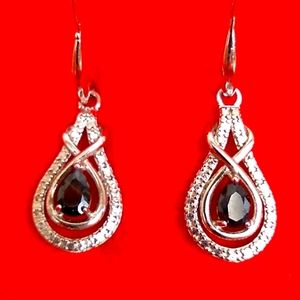 Pieced earrings of silver and dark colored crystals stone